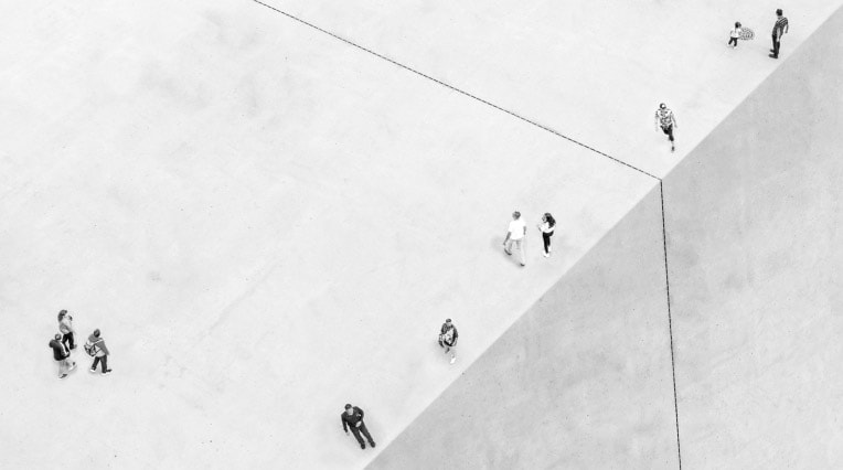 A birds eye view of people walking on a cement roof